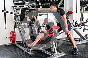 Woman using weights press machine for legs