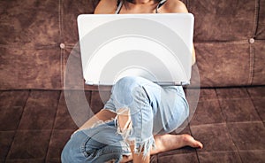 Woman using white laptop computer at home