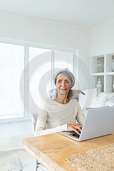 Woman using white laptop on a table.