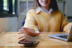 Woman using wireless charging . technology concept