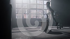 Woman using wooden box for training. Girl doing set of box jumps exercises