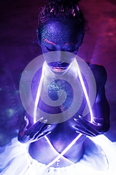 woman with UV fluorescent face and body makeup