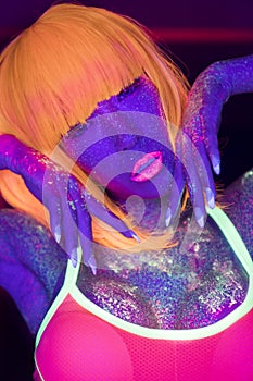 woman with UV fluorescent face and body makeup