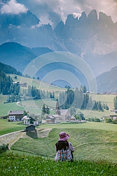 Woman on vacation in the Dolomites Italy, Santa Magdalena Village in Dolomites area Italy Val di Funes