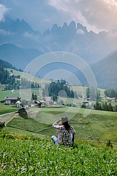 Woman on vacation in the Dolomites Italy, Santa Magdalena Village in Dolomites area Italy Val di Funes