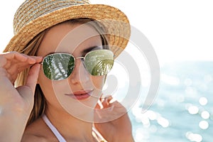 Woman on vacation. Green palm leaves mirroring in her sunglasses