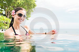 Woman in vacation relaxing swimming in pool