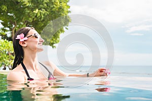 Woman in vacation relaxing swimming in pool