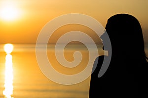 Woman at vacation at sunset, tourism concept