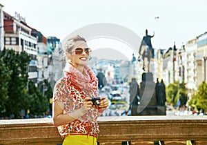 Woman on Vaclavske namesti in Prague with digital camera