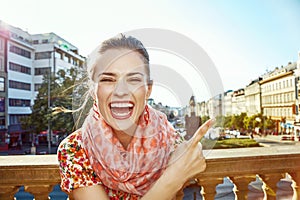 Woman on Vaclavske namesti in Prague pointing on something