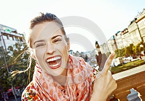 Woman on Vaclavske namesti in Prague pointing on something