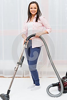 Woman vacuum cleaning carpet