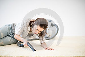 Woman vacuuming carpet