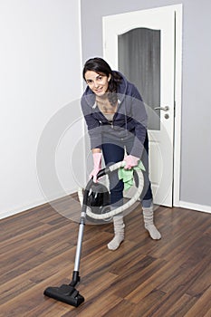 Woman vacuums the flat