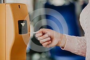 Woman validating a ticket for public transport, concept of a transportation