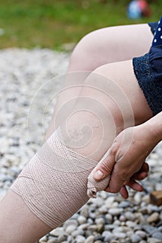 Woman with varicose veins applying compression bandage