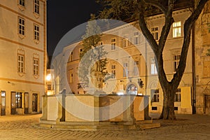 Woman with a vase statue at night near the main square of the Old Town in Bratislava, Slovakia