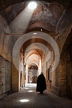 Woman in Veil Passing through Grand Old Bazaar of Yazd