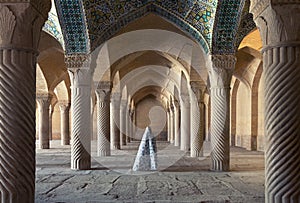 Woman in Veil Standing Between Carved Columns of Vakil Mosque in Shiraz