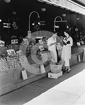 Woman and vendor at open air market photo