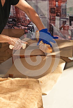 Woman vendor slicing freshly baked baguette