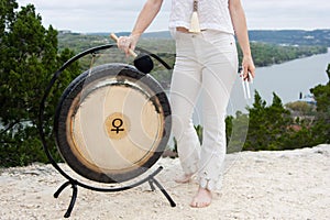 Woman With Venus Gong Outdoors