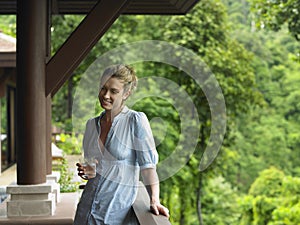 Woman In Veranda With Glass Of Water