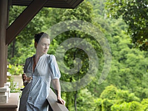 Woman In Veranda With Glass Of Water