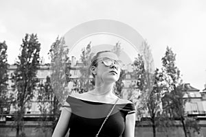 Woman in vest in paris, france. Sensual woman wear sunglasses on cityscape. Wanderlust or vacation and travelling