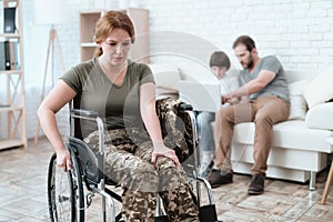 Woman veteran in wheelchair returned from army. A woman in a wheelchair is in pain. She`s in military uniform.