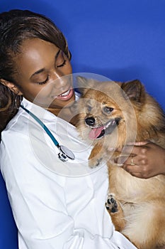 Woman veterinarian holding dog