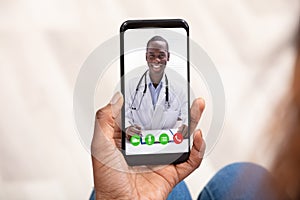 Woman Video Conferencing With Doctor On Laptop