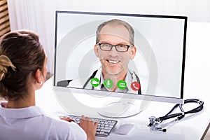 Woman Video Conferencing With A Male Doctor