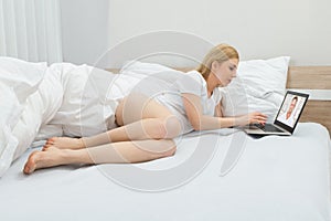 Woman Videoconferencing With Man On Laptop