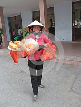 Woman in Vietnam wearing traditional triangular straw palm hats