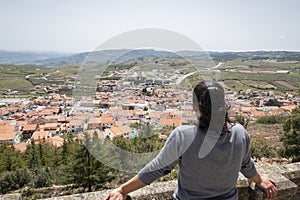 Woman at the viewpoint admiring the village photo