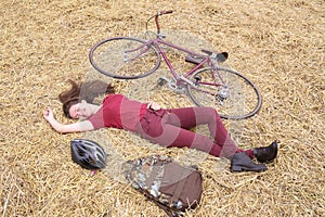 Woman with vintage bike , backbag and helmet in hay