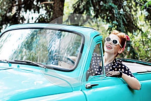 Woman in vintage clothes is driving old car after shopping.