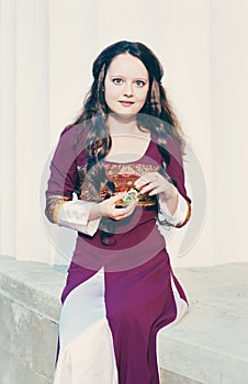 Woman in vintage dress with little bottle