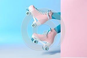 Woman with vintage roller skates on color background photo