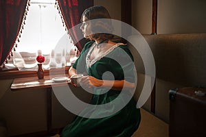 Woman in vintage train, rich compartment interior