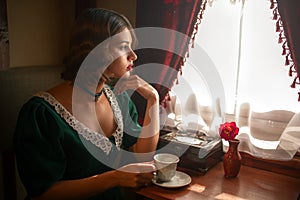 Woman in vintage train, rich compartment interior