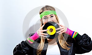 Woman with a vinyl record in 1980`s fashion