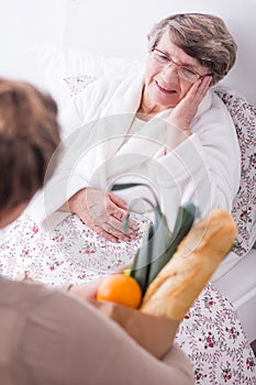 Woman visiting ill senior