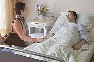 Woman Visiting Man In Hospital