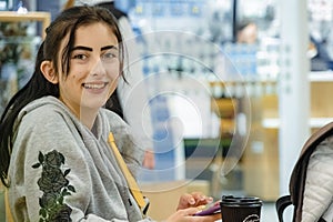 Woman visits market with coffee on table and enjoys shopping