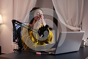 Woman vlogger blowing kisses at camera for fans while recording livestream