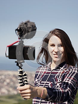 Woman Vlogging on Smartphone from Mountain