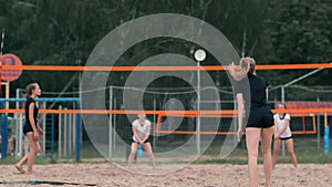 Woman volleyball serve. Woman getting ready to to serve the volleyball while standing on the beach slow motion.